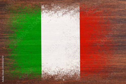 Flag of Italy. Flag is painted on a wooden surface. Wooden background. Plywood surface. Copy space. Textured background © Alex Puhovoy