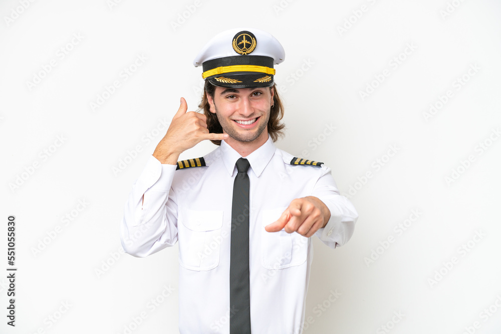 handsome Airplane pilot isolated on white background making phone gesture and pointing front handsome Airplane pilot isolated on white background making phone gesture and pointing front