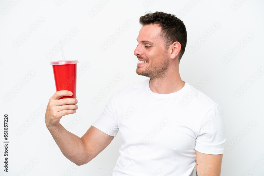 Young caucasian soda holding soda isolated on white background with happy expression Young caucasian soda holding soda isolated on white background with happy expression