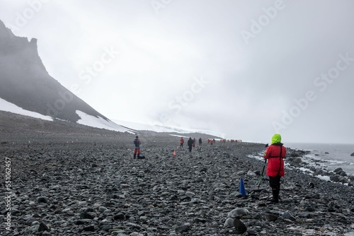 Hikers at the rocky shore in Antarctica