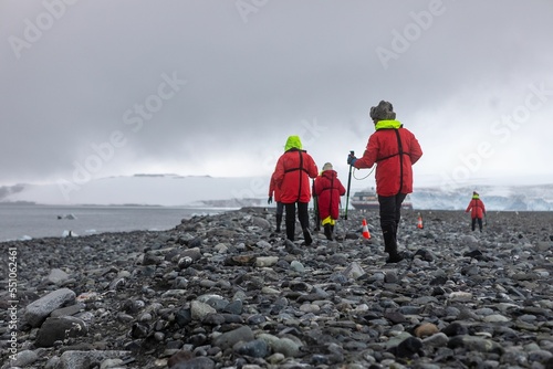 Hikers at the rocky shore in Antarctica