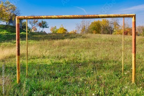 Abandoned soccer field. Overgrown grass on football pitch.