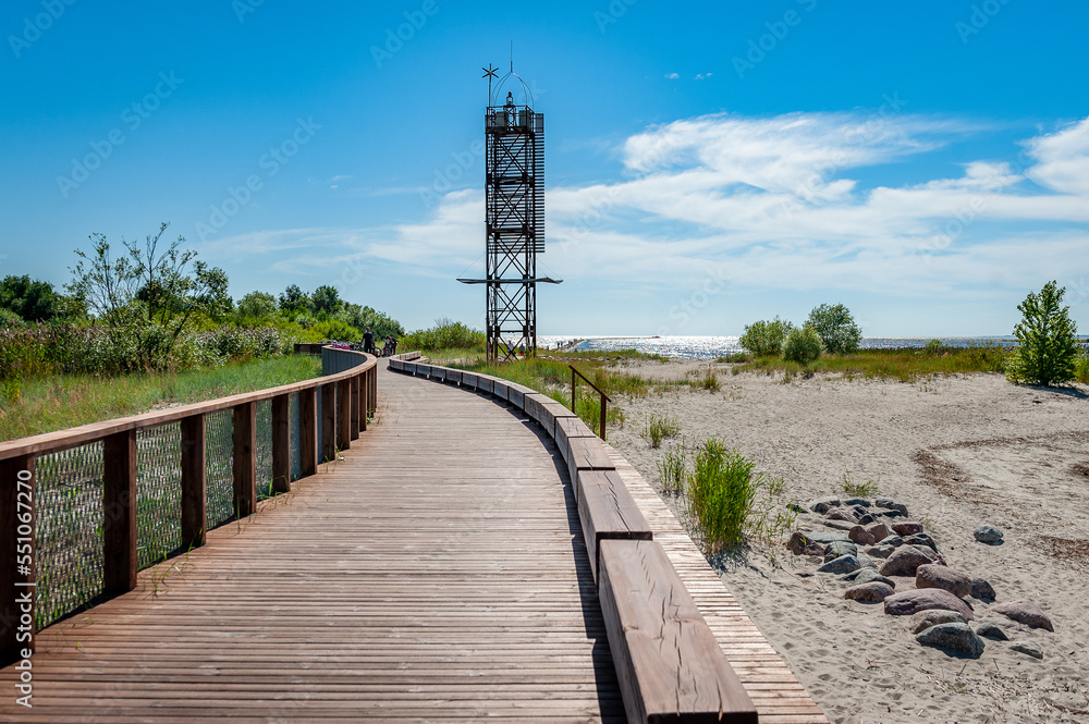 Wooden footwalk over the dunes in Parnu. Boardwalk to the baltic sea coast. Estonia.