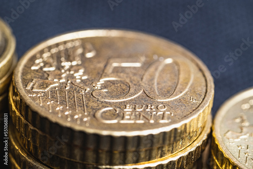 euro moyers on a black background in denominations of 20 and 50 cents. concept of economic downturn in europe photo