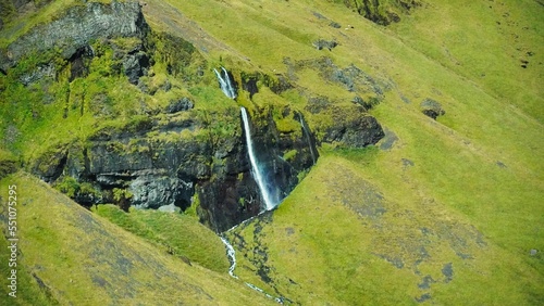 Aerial of a sunlit Glymur waterfall grass around Iceland photo