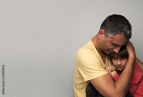 Dad hugs and comforts his daughter, the left corner is empty © Nadya