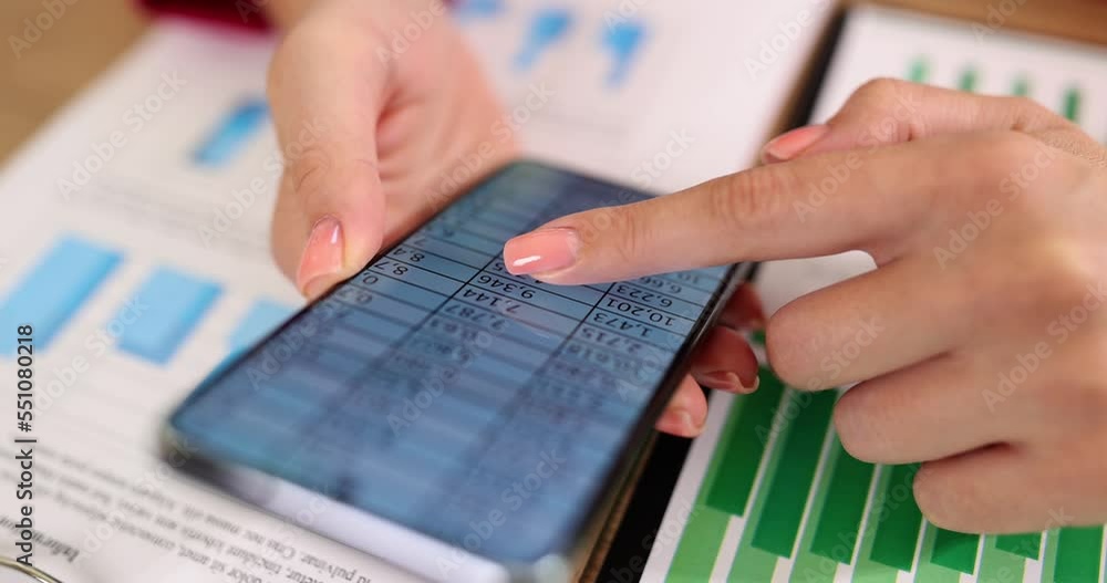 Female hands studying table with numbers on mobile phone closeup 4k movie slow motion Female hands studying table with numbers on mobile phone closeup 4k movie slow motion