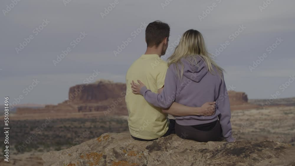 Scenic view of romantic couple admiring scenic view of desert landscape / Moab, Utah, United States Scenic view of romantic couple admiring scenic view of desert landscape / Moab, Utah, United States