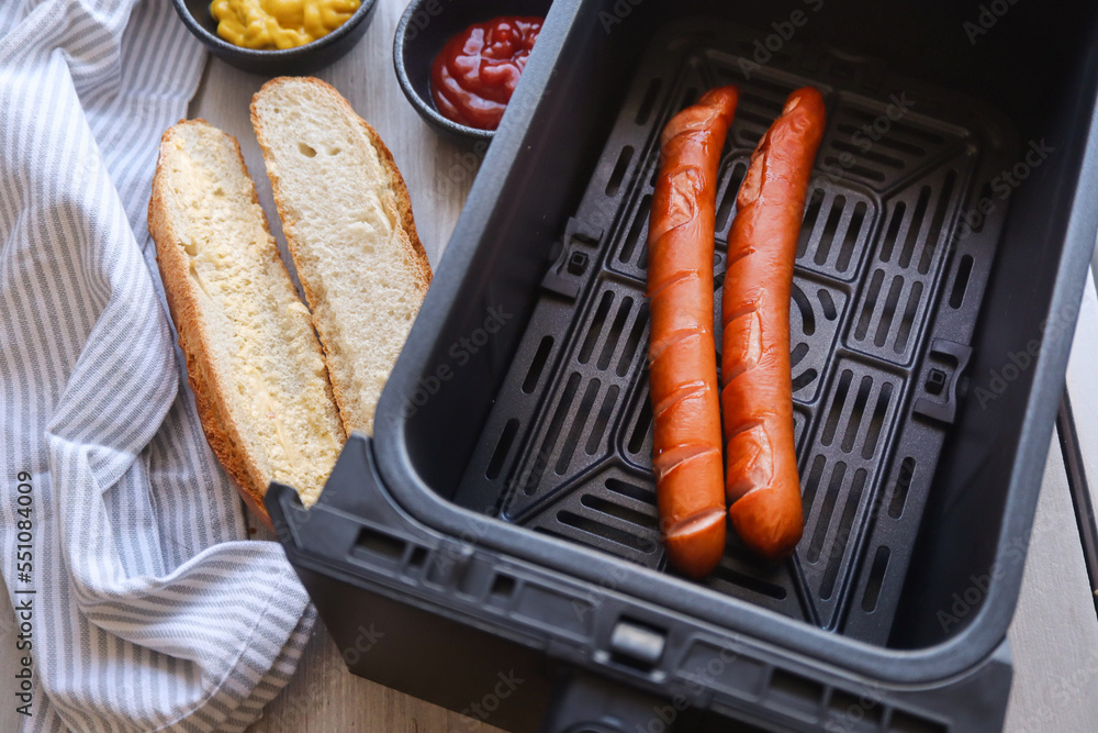 Hotdog sausages on grill. Airfryer sausages Stock Photo Adobe Stock