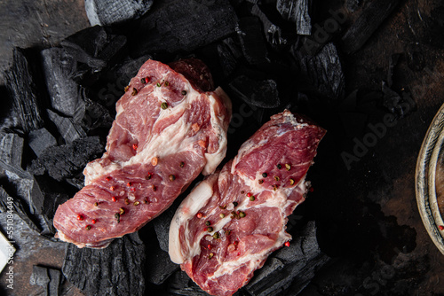 Raw pork steak on a dark background close-up