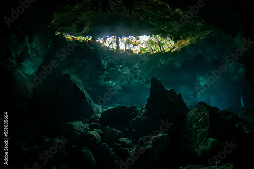 cave diver instructor leading a group of divers in a mexican cenote underwater