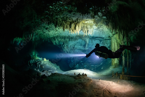 cave diver instructor leading a group of divers in a mexican cenote underwater photo