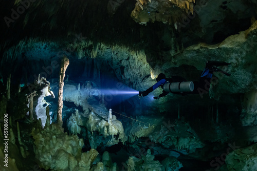 cave diver instructor leading a group of divers in a mexican cenote underwater