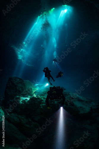 cave diver instructor leading a group of divers in a mexican cenote underwater © Subphoto