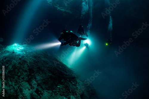 cave diver instructor leading a group of divers in a mexican cenote underwater © Subphoto