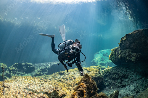 Obraz na plátně cave diver instructor leading a group of divers in a mexican cenote underwater