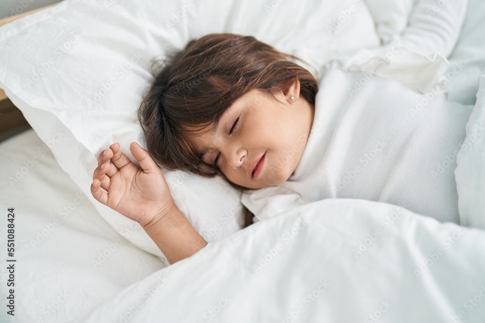 Adorable hispanic girl lying on bed sleeping at bedroom Adorable hispanic girl lying on bed sleeping at bedroom