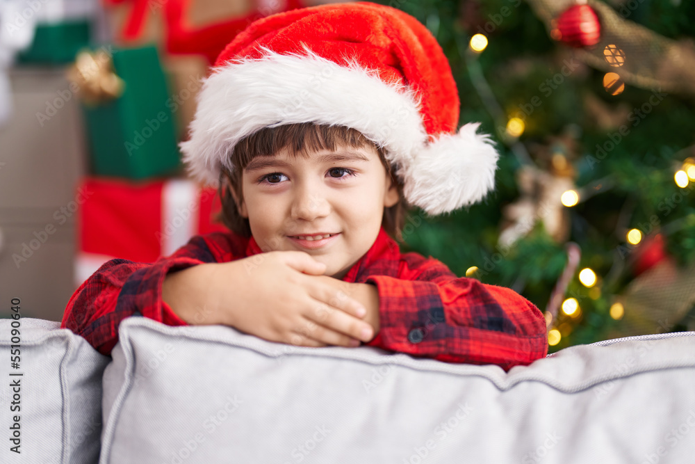 Adorable toddler smiling confident standing by christmas tree at home Adorable toddler smiling confident standing by christmas tree at home