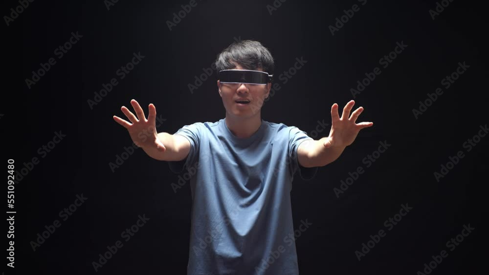 Asian Man Making Gestures With Hands In Air, Play 3D Video Game In Futuristic Goggles
Asian Man Making Gestures With Hands In Air, Play 3D Video Game In Futuristic Goggles