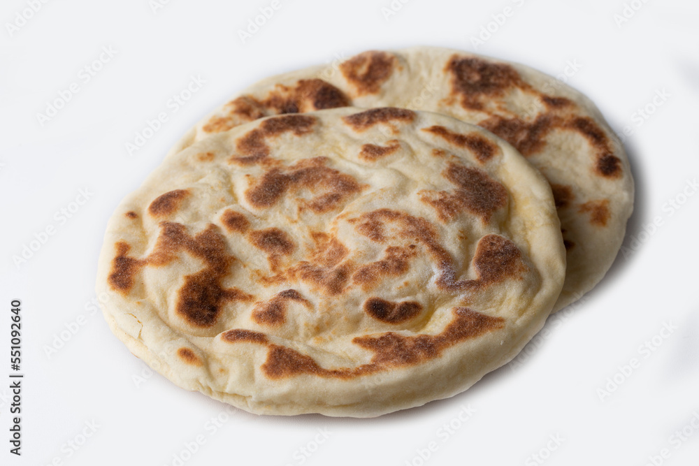 Turkish flat bread bazlama on white background Turkish flat bread bazlama on white background