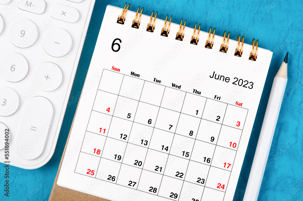 Close up the June 2023 Monthly desk calendar for 2023 year with calculator and wooden pencil. Close up the June 2023 Monthly desk calendar for 2023 year with calculator and wooden pencil.