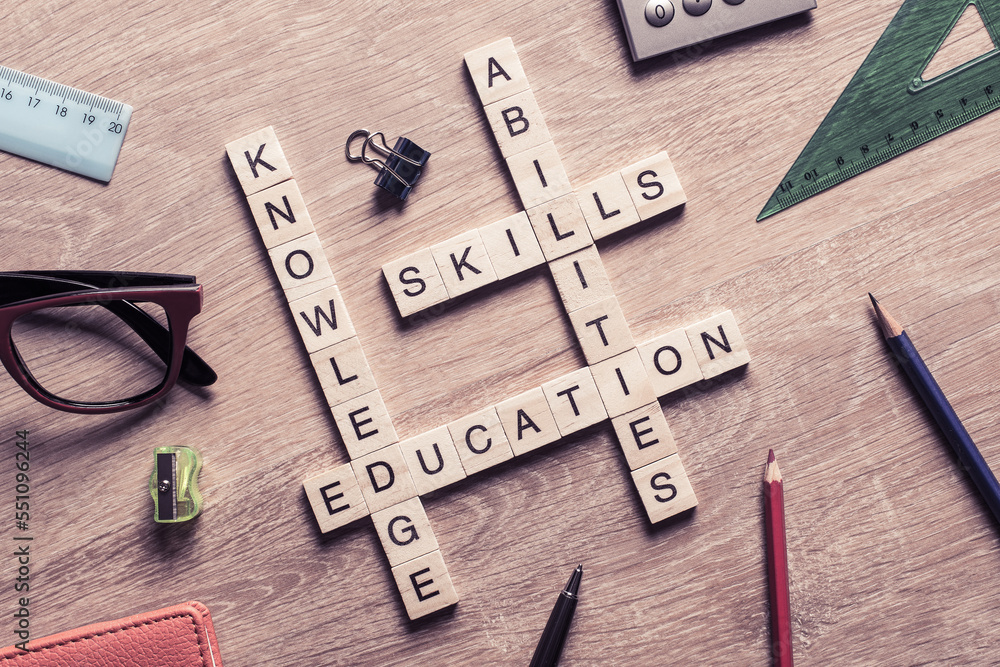 Conceptual keywords on wooden table with elements of game making crossword Conceptual keywords on wooden table with elements of game making crossword