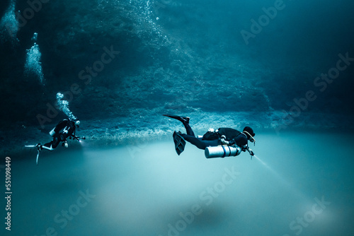 Obraz na plátně cave diver instructor leading a group of divers in a mexican cenote underwater