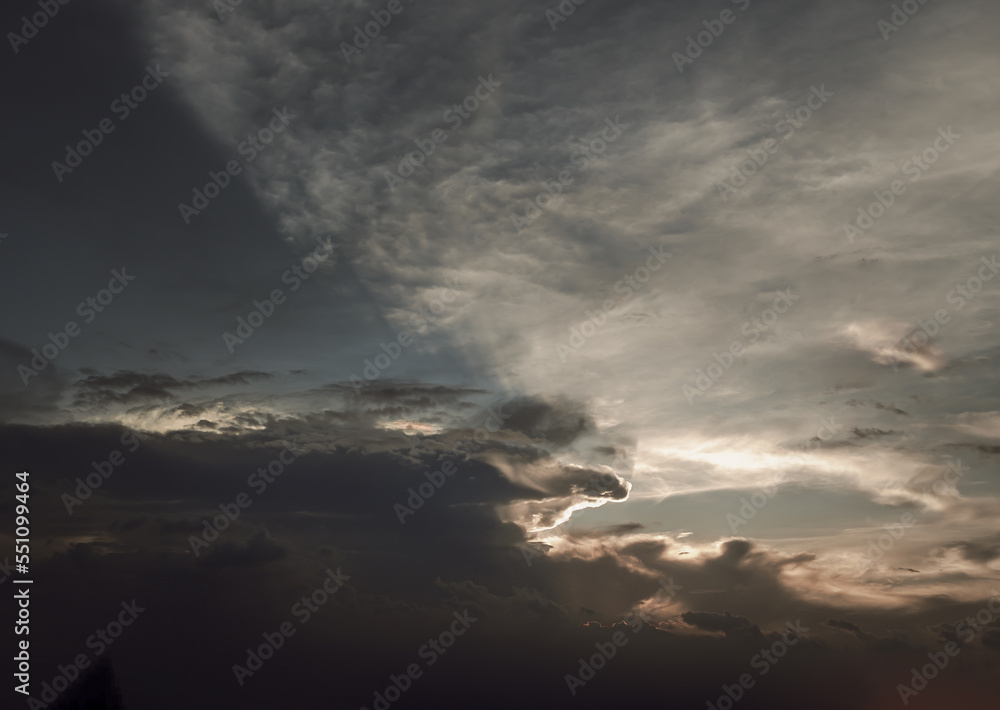 Obraz premium The sun's rays passing through the clouds and shining form an interesting light pattern against the sky. Space for text, Selective focus.
