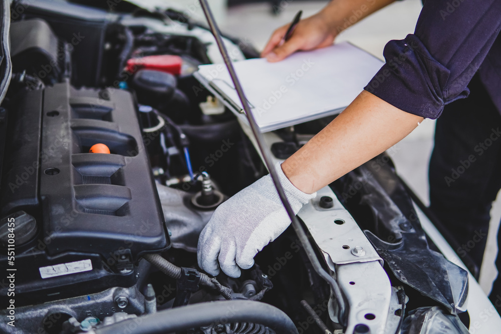 Maintenance man check engine of a car close up Maintenance man check engine of a car close up