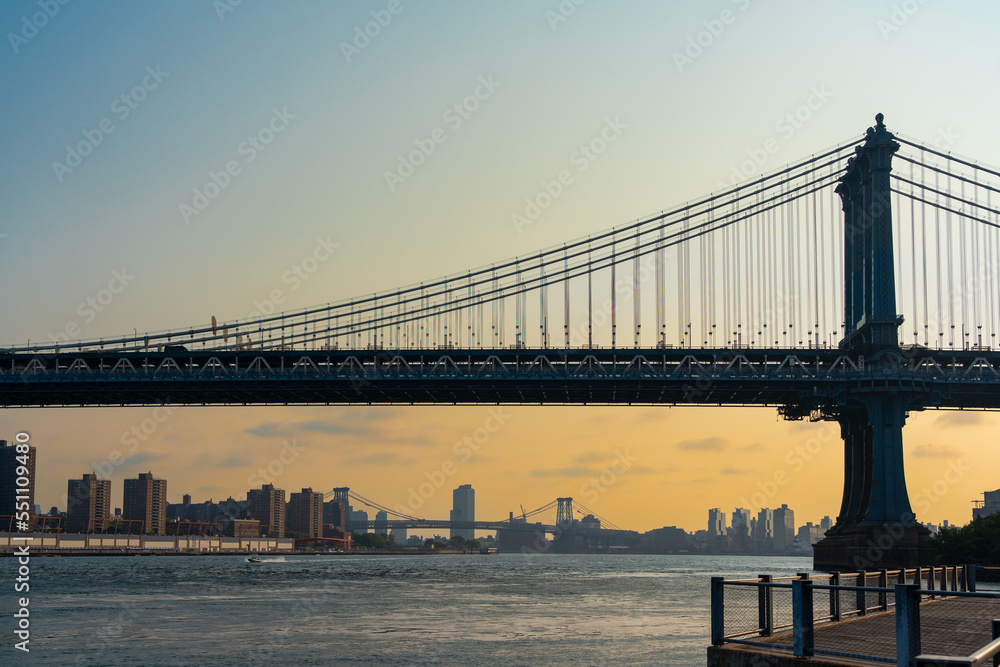 Silhouette of the Manhattan bridge against the backdrop of the sunset sky over New York