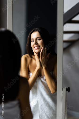 Portrait of young beautiful healthy woman and reflection in the mirror