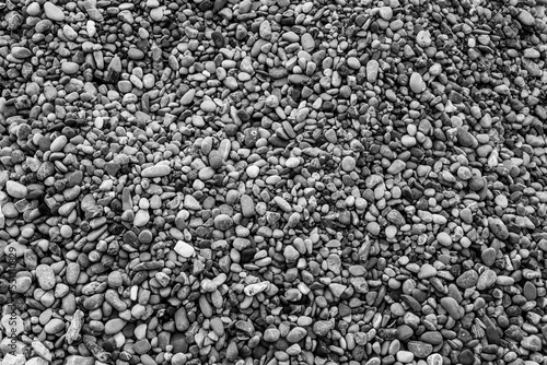 Background from beach pebbles, top view. Pebble texture for a poster, calendar, post, screensaver, wallpaper, postcard, banner, cover, website. High quality photography