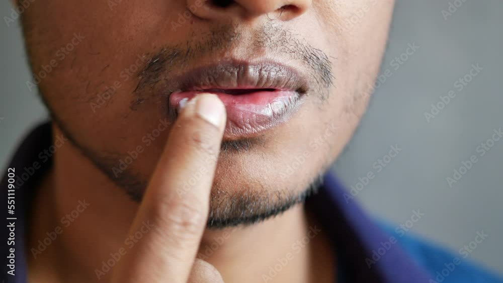 men applying petroleum jelly on mouth lip men applying petroleum jelly on mouth lip