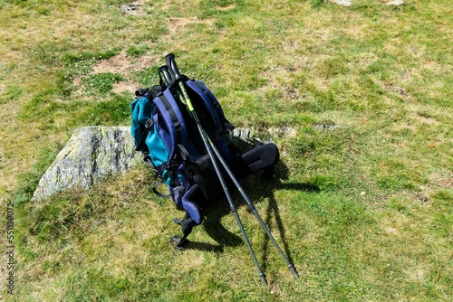 Trekking equipment, large backpack and telescopic poles.
