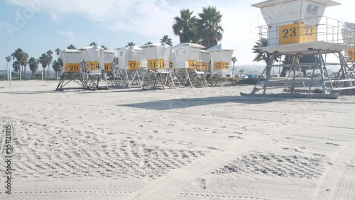 Lifeguard stand and palm tree, life guard tower for surfing on California beach. Summer pacific ocean in USA aesthetic. Iconic rescue baywatch station, coast lifesavers wachtower hut or house by sea.