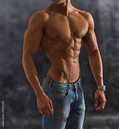 Three quarters shot of handsome shirtless athletic young man