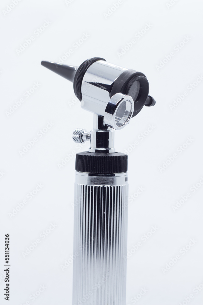 metallic otoscope on illuminated white background metallic otoscope on illuminated white background