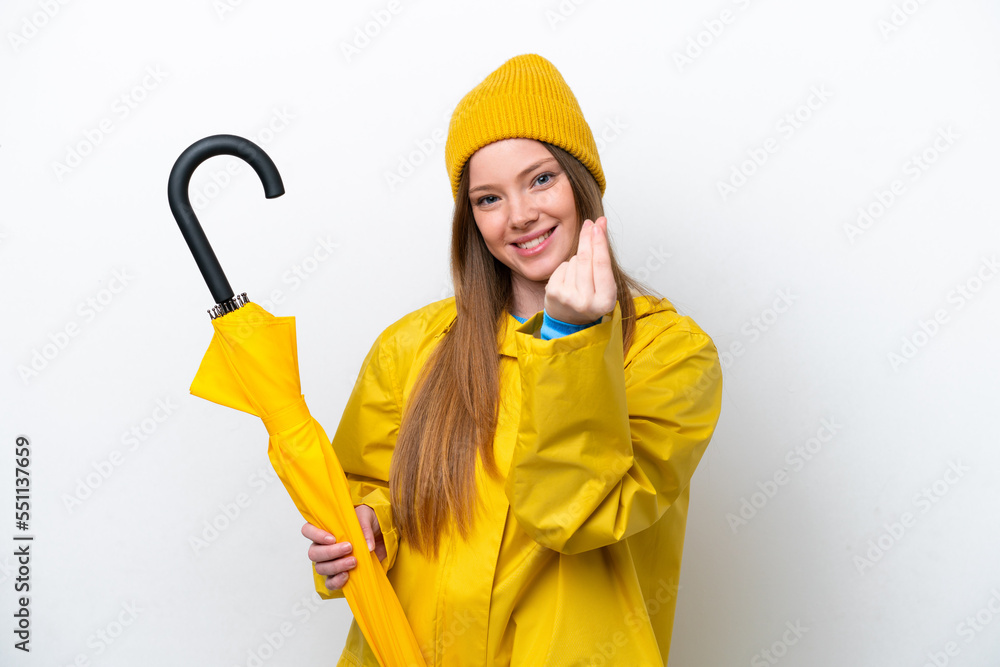Young caucasian woman with rainproof coat and umbrella isolated on white background making money gesture Young caucasian woman with rainproof coat and umbrella isolated on white background making money gesture