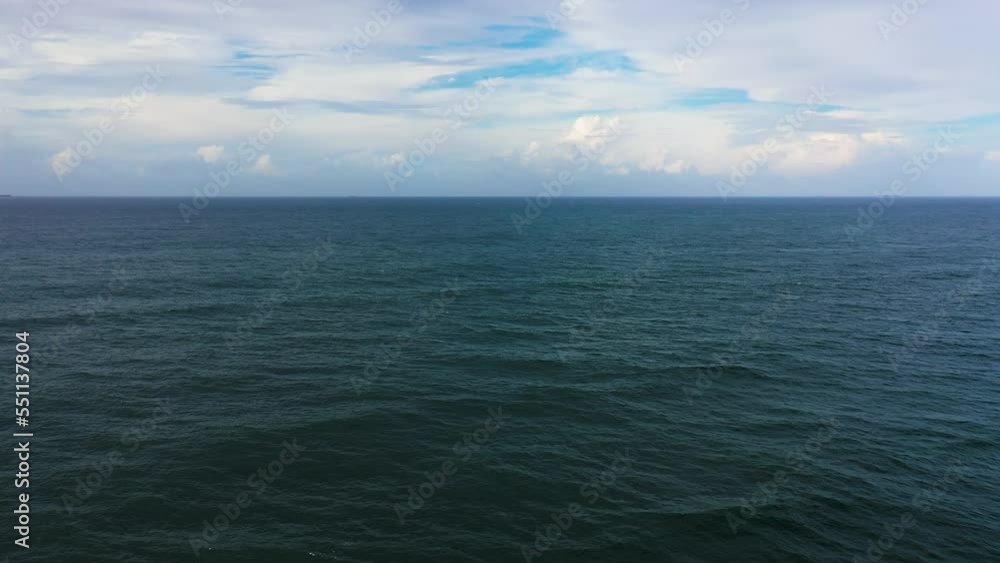 Tropical blue sea and blue sky with clouds. Seascape, aerial view. Flight over the sea. Summer and travel vacation concept. Tropical blue sea and blue sky with clouds. Seascape, aerial view. Flight over the sea. Summer and travel vacation concept.