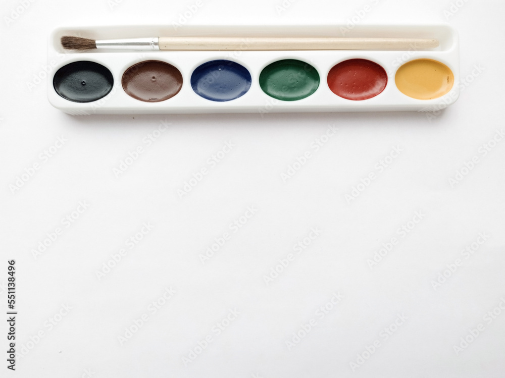 Brush and paint on a white background. Everything for drawing. Creation. Children is creativity. Hobby. Colored paints and gouache. Brush and paint on a white background. Everything for drawing. Creation. Children is creativity. Hobby. Colored paints and gouache.