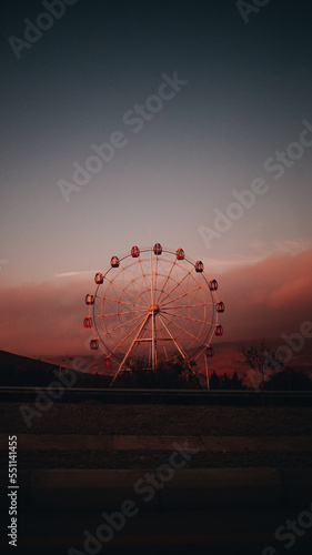 Ferris wheel at sunset in the desert photo