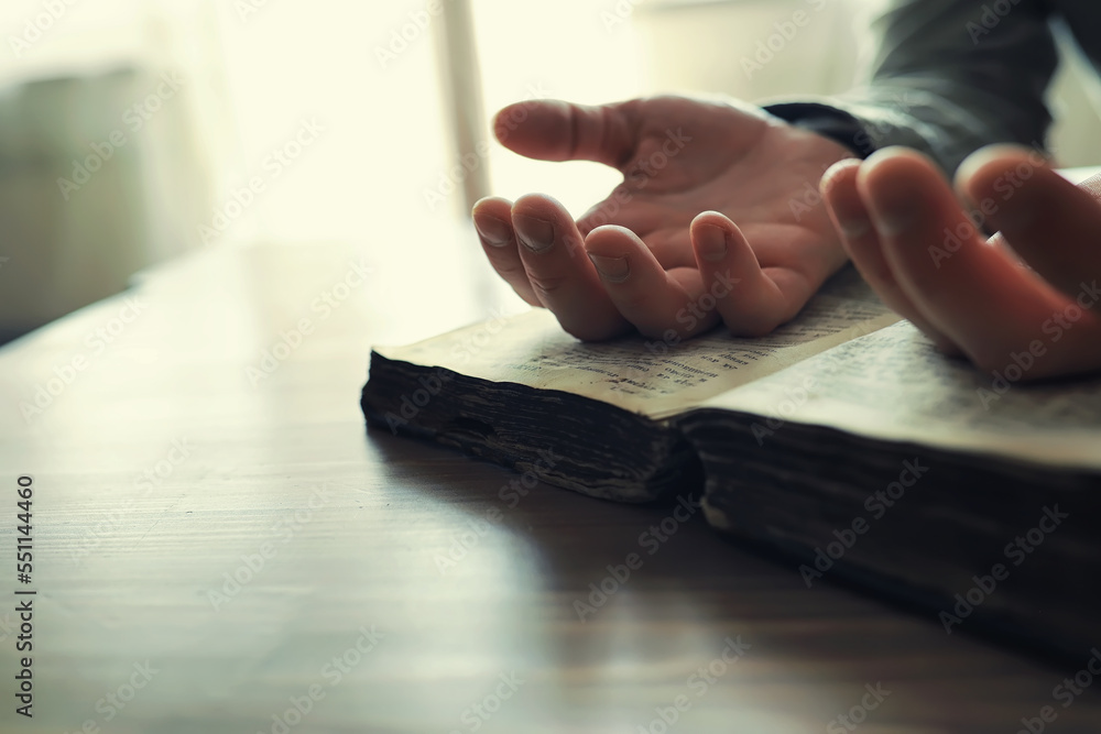 Fototapeta premium Reading religious literature. A man studies the Koran and sorts out the rosary.