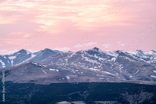 Crimson sunset sky with snow on the mountains