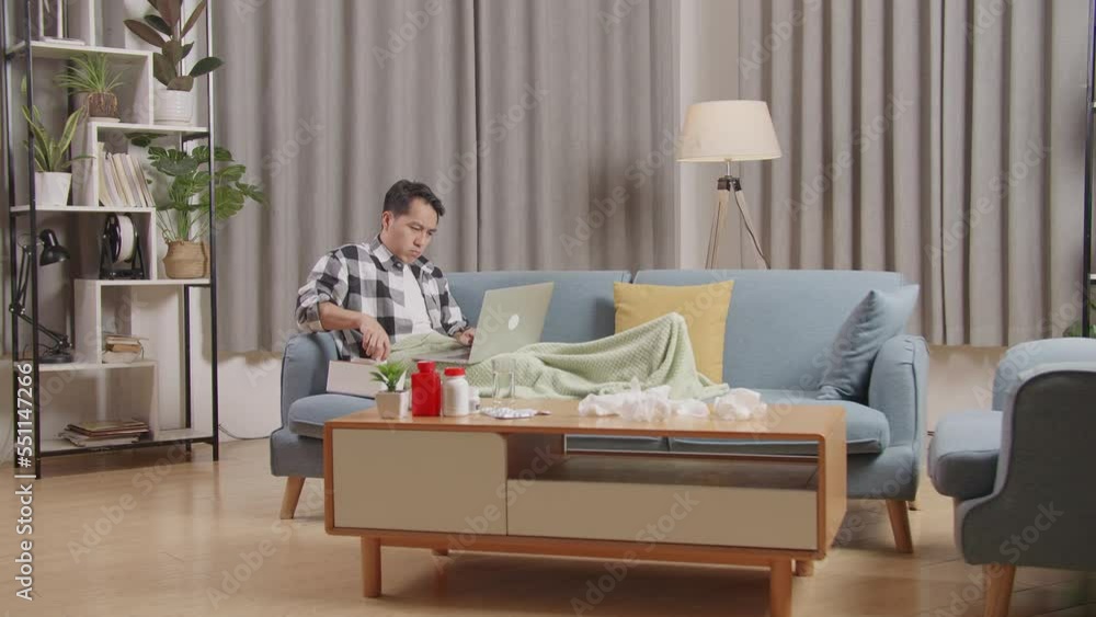 Asian Man With Blanket Blows Sneezes Wipes Snot Into Tissue While Lying On Sofa Works On A Laptop Computer In The Living Room At Home
Asian Man With Blanket Blows Sneezes Wipes Snot Into Tissue While Lying On Sofa Works On A Laptop Computer In The Living Room At Home
