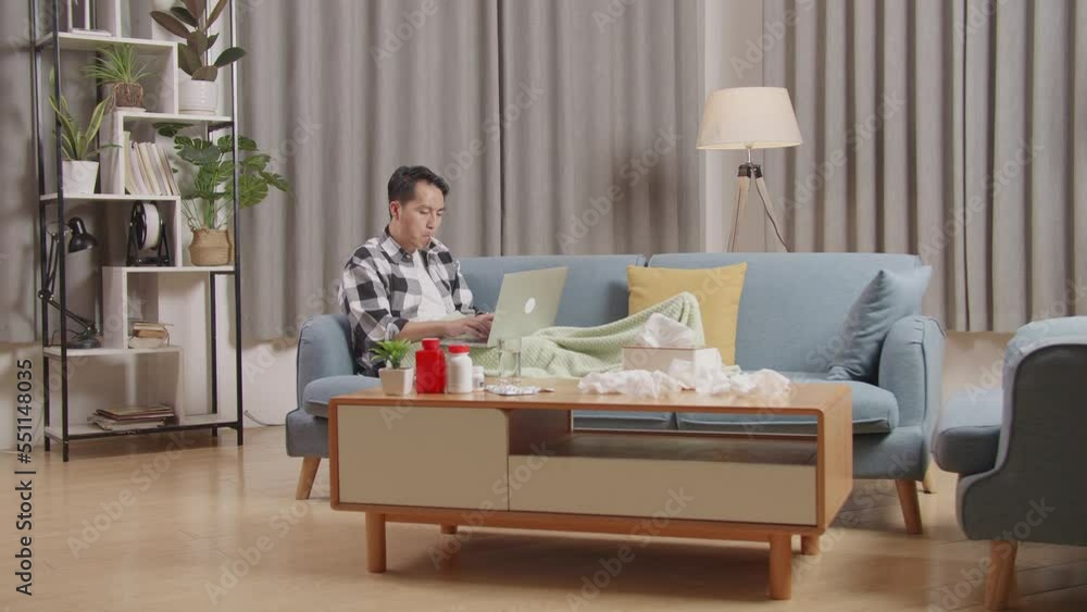 Asian Man With Blanket Using Thermometer Test For Flu, Cold And Body Temperature While Lying On Sofa Works On A Laptop Computer In The Living Room At Home
Asian Man With Blanket Using Thermometer Test For Flu, Cold And Body Temperature While Lying On Sofa Works On A Laptop Computer In The Living Room At Home