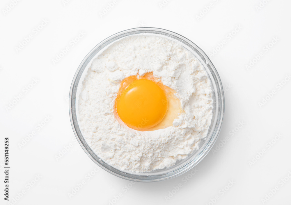 Bowl plate with flour and egg yolk on white background. Bowl plate with flour and egg yolk on white background.