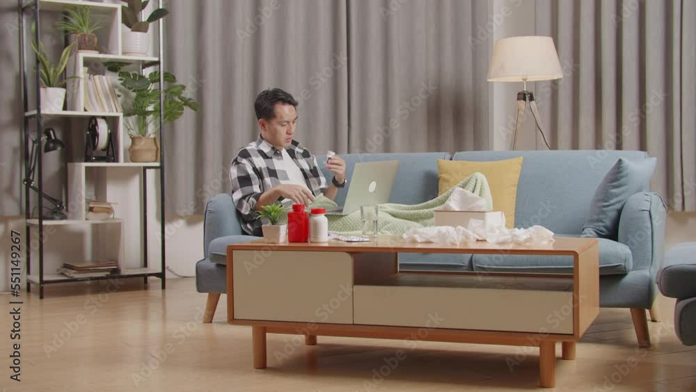 Sick Asian Man With Blanket Holding Medicine To The Video Call With Doctor On A Laptop While Lying On Sofa In The Living Room At Home
Sick Asian Man With Blanket Holding Medicine To The Video Call With Doctor On A Laptop While Lying On Sofa In The Living Room At Home