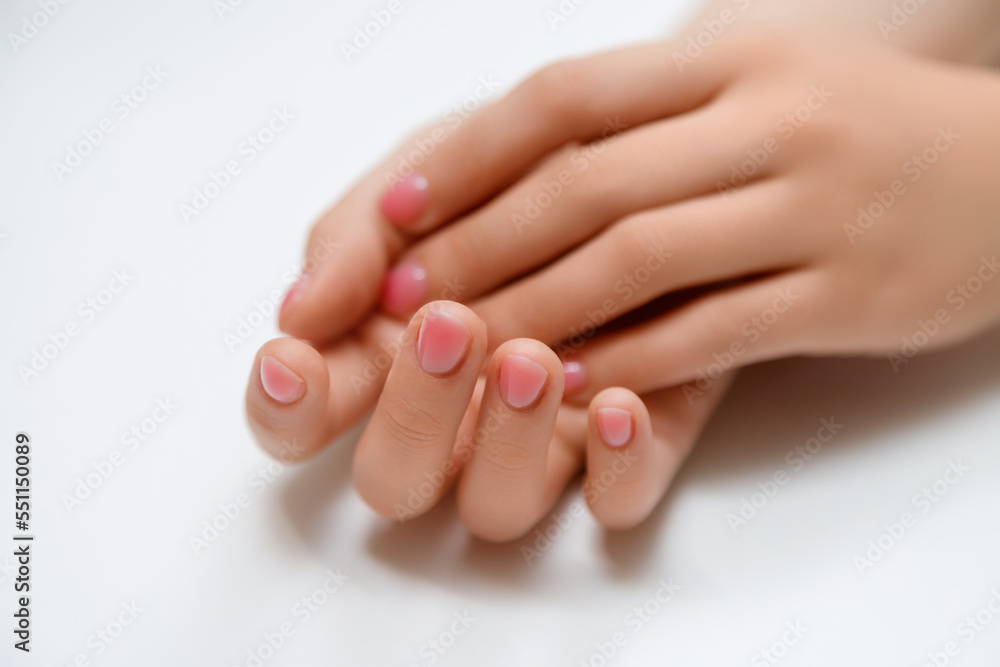Closeup top view of elegant pastel pink natural manicure. Female hands isolated on white background. Horizontal color photography. Closeup top view of elegant pastel pink natural manicure. Female hands isolated on white background. Horizontal color photography.