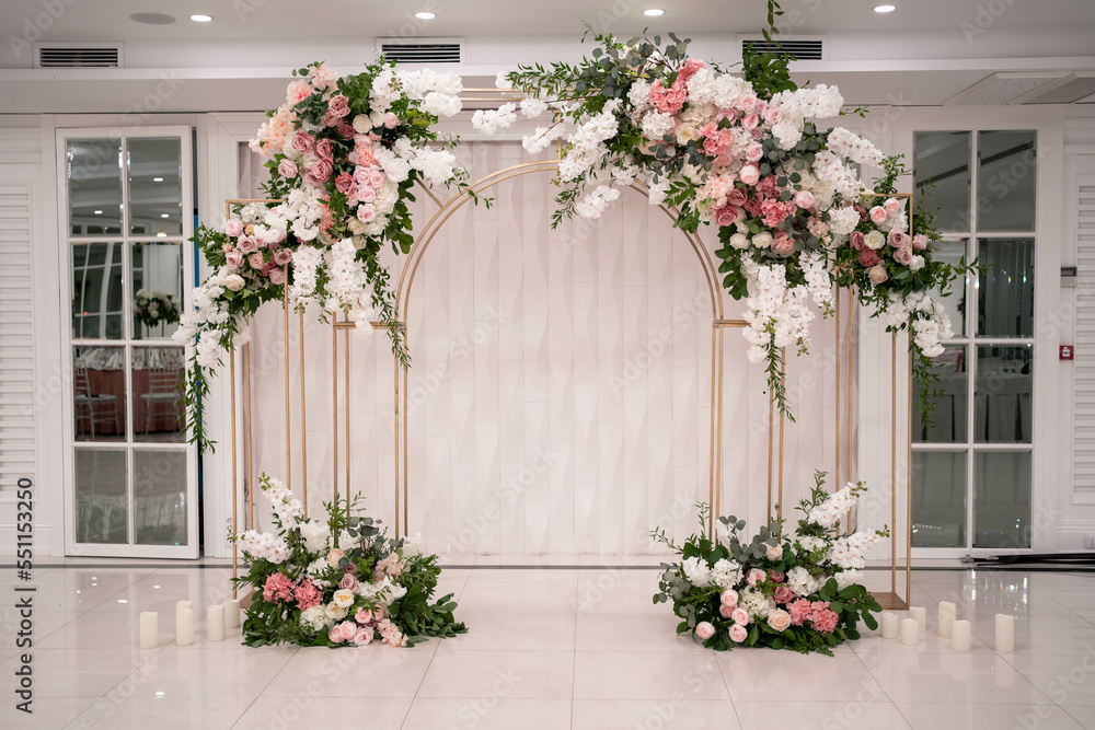 Arch for the wedding ceremony, decorated with white and pink flowers.