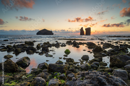 Amazing sunset at the beach of Mosteiros with its islets, Azores Sao Miguel island, Portugal. Sunset landscape over the sea at the coasts on a beautiful summer evening. Seascape.